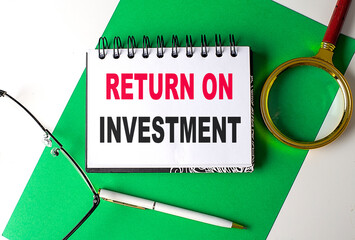Poster - RETURN ON INVESTMENT text on notebook on green paper