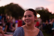 © Austockphoto - teenage girl at a gig at sunset