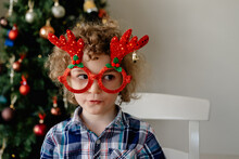 Happy, Young Boy Wearing Novelty Glasses Celebrating Christmas At Home In Australia