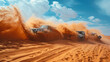 A group of adventurers dune bashing in 4x4 vehicles stirring up clouds of sand.