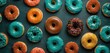  a bunch of different kinds of doughnuts with different toppings on a black surface with green, orange, and yellow sprinkles on the top of the doughnuts.