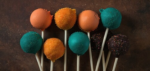 Canvas Print -  a group of cake pops sitting on top of each other on top of a wooden table with sprinkles on top of them and on top of them.