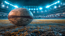 Close up photo of rugby, American football ball lying on green grass of field illuminated with spotlights at night. Sport games.