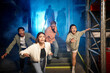 © LIGHTFIELD STUDIOS - four young multicultural friends running from scary people in gas masks and ppe suits in escape room