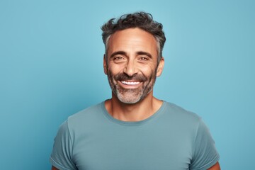 Wall Mural - Portrait of a cheerful man in his 40s donning a trendy cropped top against a pastel gray background. AI Generation
