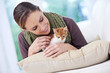© Katie/peopleimages.com - Happy, pet and woman with kitten in home for bonding, friendship and relax together on sofa. Animal care, house and person with adorable, cute and young cat on couch for playing, training and love