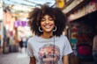 Portrait of a joyful afro-american woman in her 20s sporting a vintage band t-shirt against a vibrant market street background. AI Generation