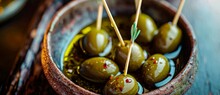A vibrant array of plump, golden olives, adorned with toothpicks, invite you to savor the natural beauty and delicious taste of this mediterranean vegetable dish