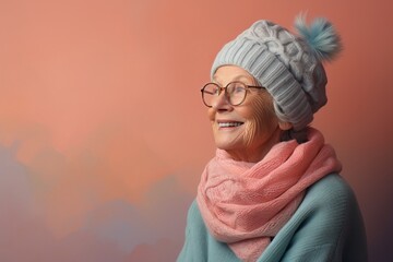 Sticker - Portrait of a glad woman in her 70s donning a warm wool beanie against a pastel or soft colors background. AI Generation