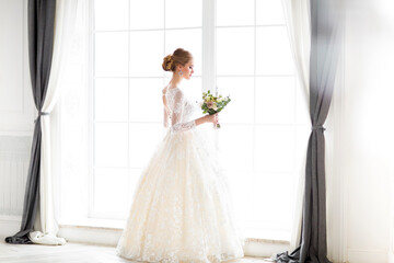 Young beautiful blond woman posing in a wedding dress