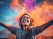 Holi Fest celebration, young woman celebrating with his arms in the air, happy and dancing, with a whole cloud of color behind him. Artificial intelligence generated
