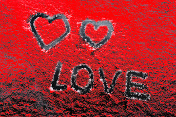 the word love and two hearts on a red background