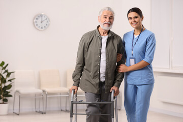 Poster - Smiling nurse supporting elderly patient in hospital, space for text