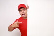 © ArvStd - Wow excited Asian courier man in red pointing presenting something on blank board. Advertisement concept