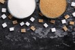 Different types of sugar in bowls on dark gray textured table, flat lay. Space for text