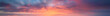 Vibrant extra wide panoramic sky. Fantasy banner sky. Rich colors. Daytime sunset beauty. Fiery glowing heavenly sky with gradient colors. Red, pink, orange, blue, yellow. Dark stormy clouds