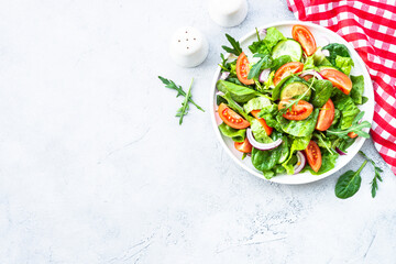 Canvas Print - Green salad with leaves and vegetables. Vegan food, diet meal. Top view with copy space at stone table.