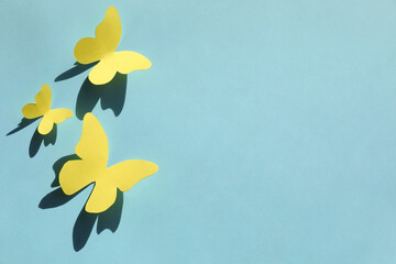 Poster - Yellow paper butterflies on turquoise background, top view. Space for text