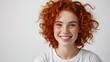 Closeup of happy attractive young woman with short red hair and freckles wears stylish t shirt looks happy and smiling isolated over white background.
