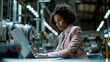 © MP Studio - Young woman is focused on working on her laptop in a modern office