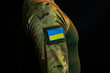  A soldier with the chevron of the national flag of Ukraine on his shoulder.