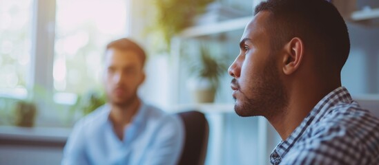 Sticker - Closeup of psychotherapist assisting young man in office setting.