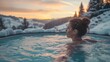 A woman relaxing in a hot bath in the snowy mountains. Woman with snowflakes in her hair relaxing in hot tub with panoramic view in cold winter.