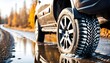 Single car tire standing on the road in difficult weather conditions, in snow or rain wet road with aquaplaning