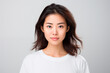 © Lucas - Portrait of a 30 years old asian woman in casual dress looking at the camera. studio shot, isolated, grey background. Generative AI