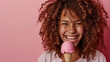 Happy curly child looking at camera and holding ice cream