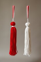 Wall Mural - Red and white Martisor, Martenitsa tassel symbolizing springs arrival on beige isolated background. Traditional Moldavian, Romanian, Bulgarian 1 March