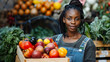Portrait of a black female working at a farmers market stall with fresh organic agricultural products looking at camera and smiling