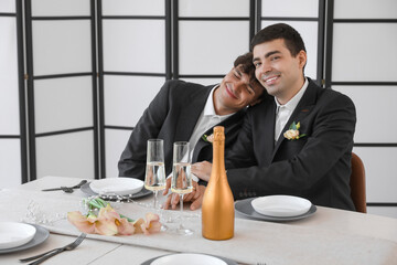 Poster - Happy gay couple at table on their wedding day