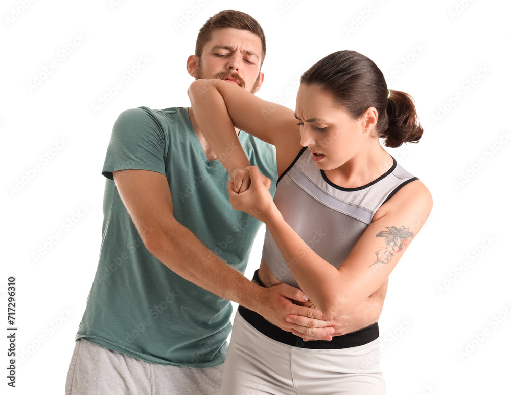 Young woman fighting with instructor of self-defence course on white background