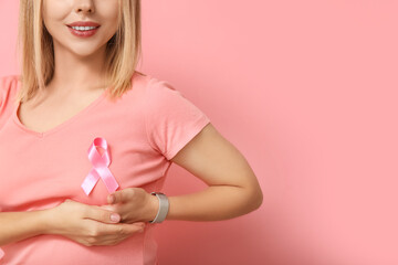 Sticker - Young woman with ribbon on pink background.  Breast cancer awareness concept