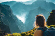 © Michael - Portrait of a female backpacker tourist with a view of the breathtaking view into the depths of the volcanic mountain landscape. Pico do Arieiro, Madeira Island, Portugal, Europe.