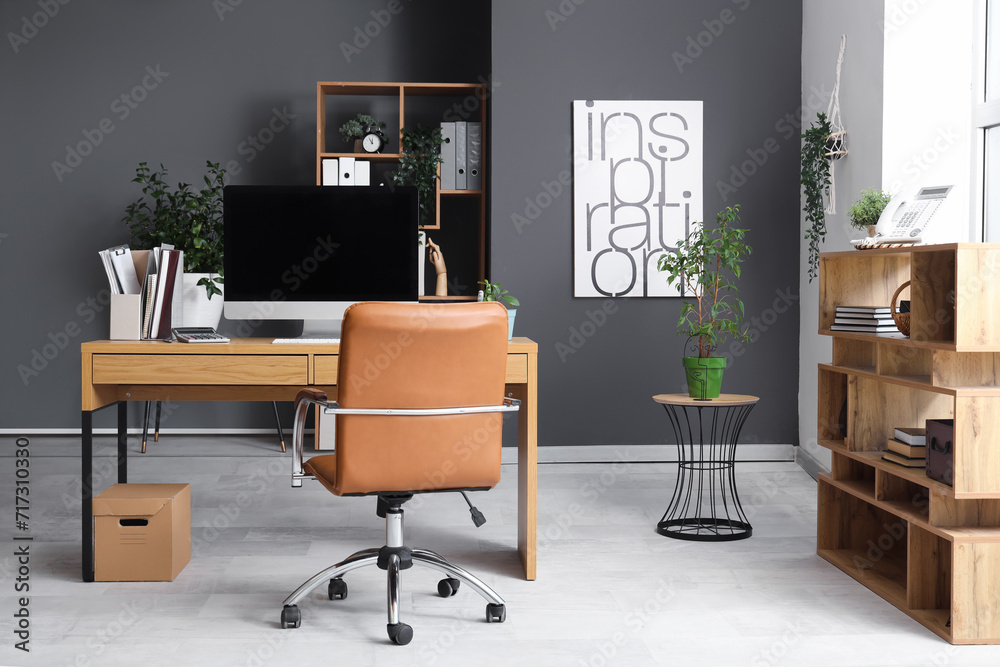 Interior of modern office with workplace and shelf units