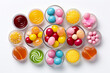 Set of colorful chewing candies in round bowls on white background, flat lay.