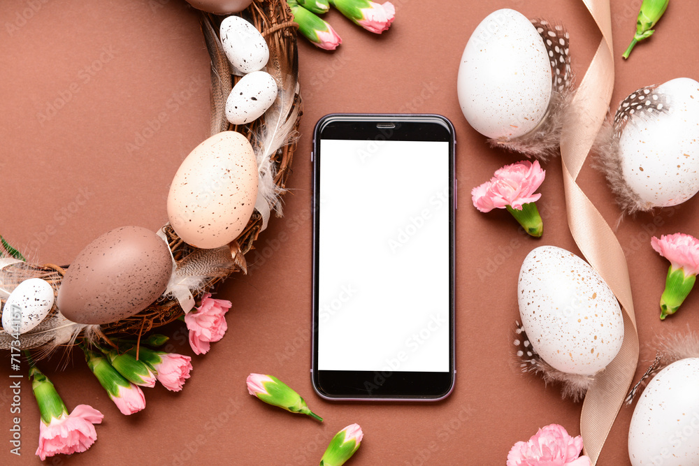Composition with modern mobile phone and beautiful Easter decor on color background
