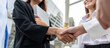 © Kawee - Close up of businesswoman and man making handshake outdoor in the city.