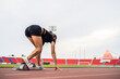 © Kawee - Asian young sportswoman sprint on a running track outdoors on stadium.