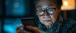 Middle-aged Asian woman with blurred vision holding glasses struggles to read text message on smartphone screen due to presbyopia, an eye disease resulting in farsightedness in older individuals.