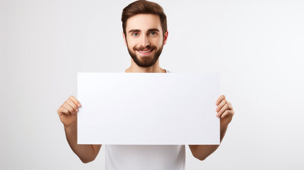 Canvas Print - a handsome man holding a blank placard sign poster paper in his hands