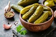 Pickled gherkins with mustard and garlic on stone