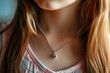 Heart shaped silver medallion pendant hangs around young girl s neck on a chain adding a touch of romance with its beautiful design