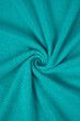 fragment of a green towel. The color is bright brilliant green. rolled texture.​