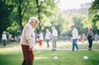 © studioworkstock - elderly people playing bocce ball in a park