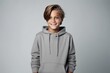 © Iigo - A portrait of a cute little boy in a hoodie on a gray background