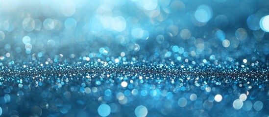 Poster - Abstract photo background of metallic glitters on glossy blue sand with small bokeh texture.