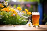 Fototapeta Sport - amber ale in garden, flowers and daylight